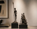 Lot de deux sculptures africaines en bronze patiné – Guerrier & scène de village